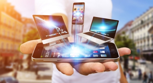 43158792 - businessman with computer phone and tablet in his hand